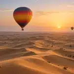 Illustrative hot air balloon flight over the Dubai desert at sunrise