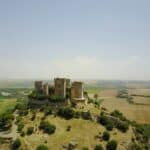 brown concrete castle near green trees during daytime