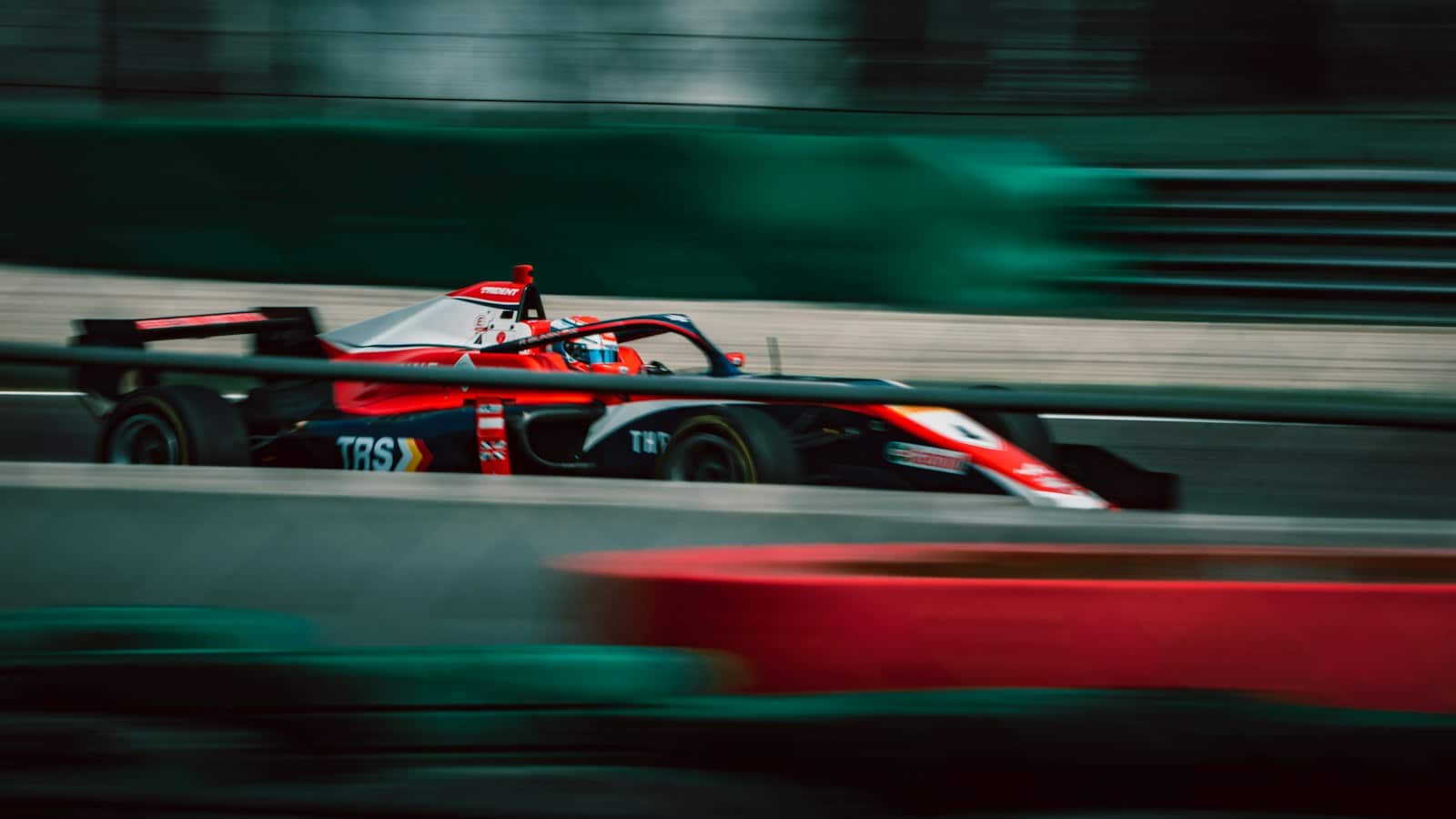 Ramal Tours – f1 a man driving a race car on a track