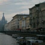 a canal with boats and buildings along it